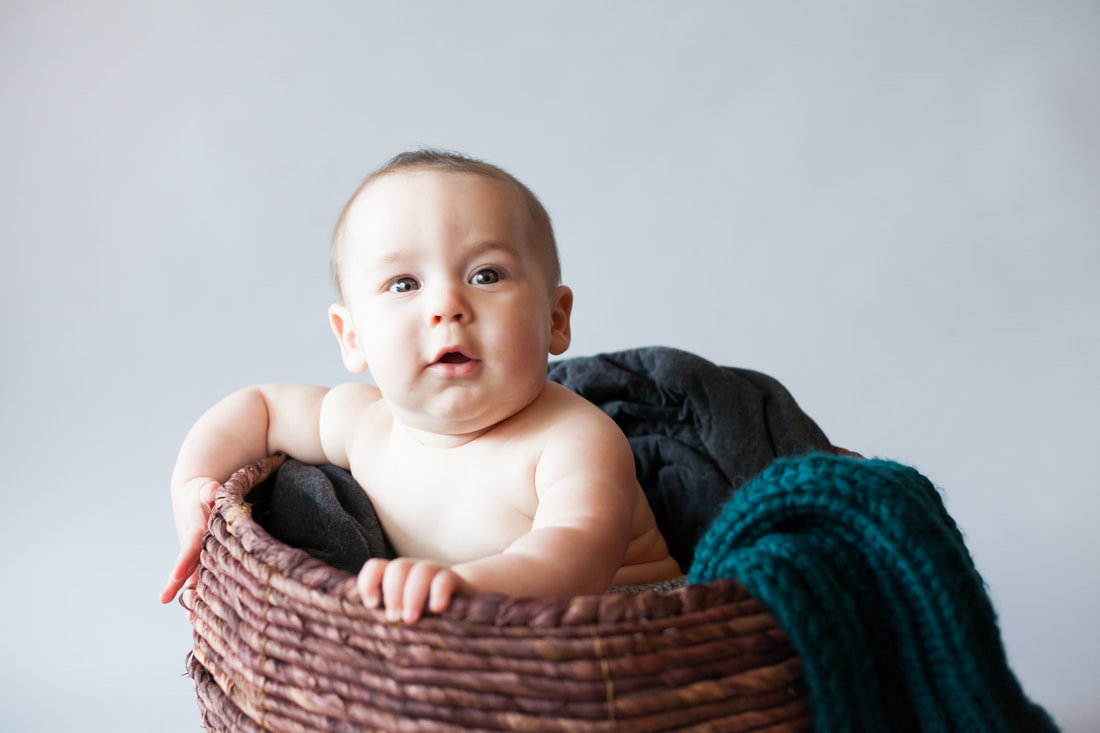 close up of Six month old baby in basket 