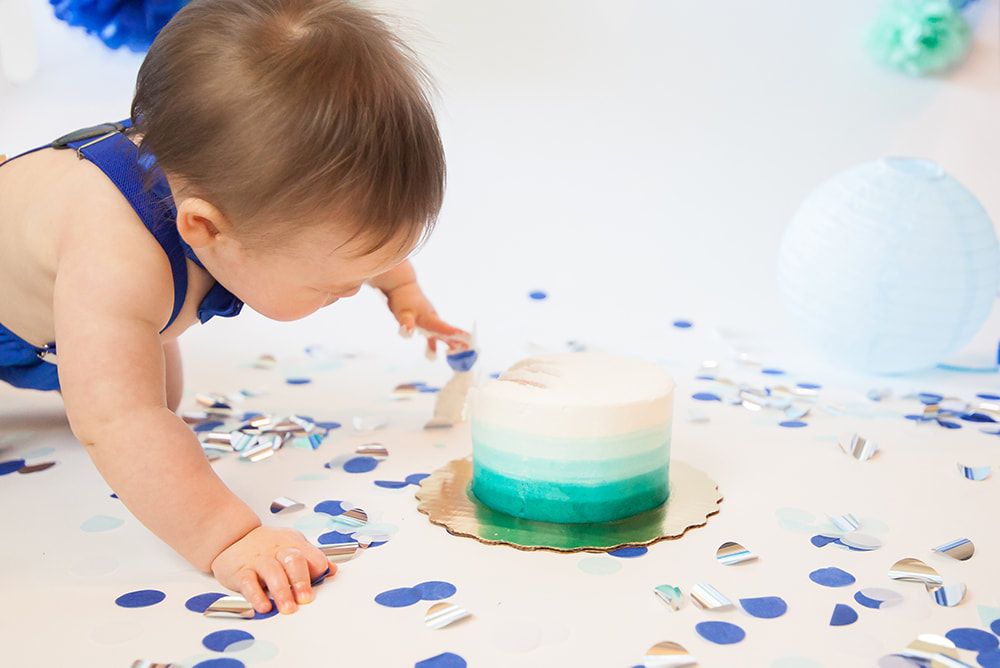 baby boy reaching for cake