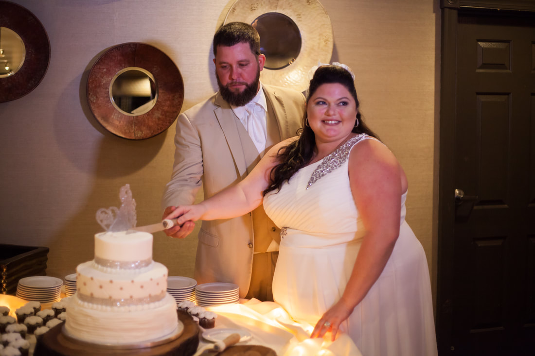 Bride and Groom cup the cake at hernando wedding venue
