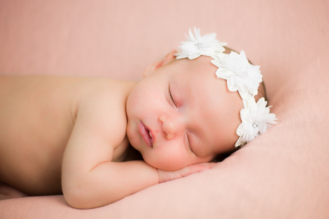 Newborn baby with flower headband