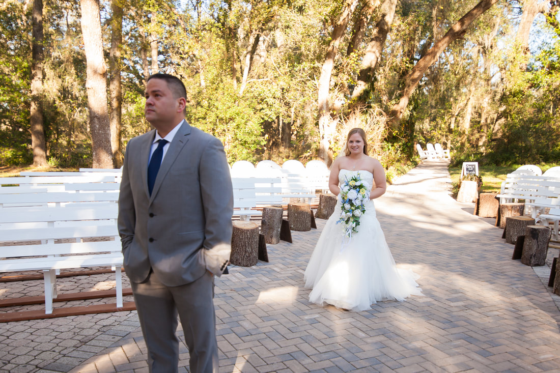 dade city bride walks up behind groom for first look