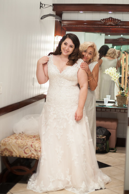 Wedding Photography Bride and mother admire bride in mirror