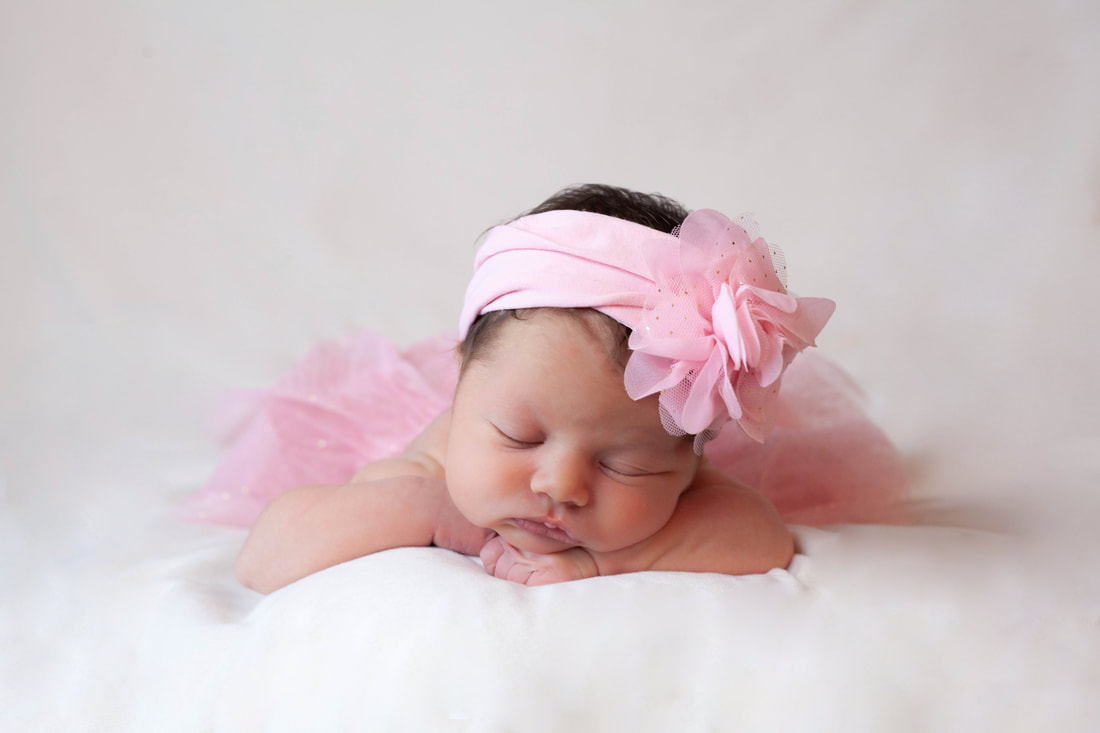 Newborn Baby girl in pink tutu on white background