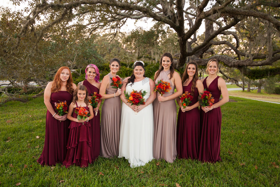 Bride posing with bridesmaids in front of beautiful Oak tree at Citrus Hills Country Club