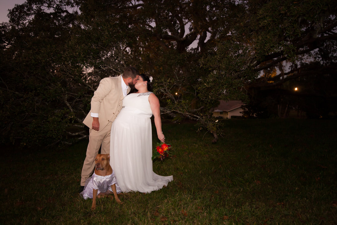 Bride and groom kiss at night at Citrus Hills Country Club
