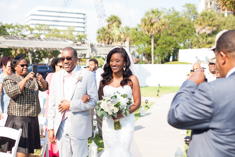 Bride walking down the aisle accompanied by her father