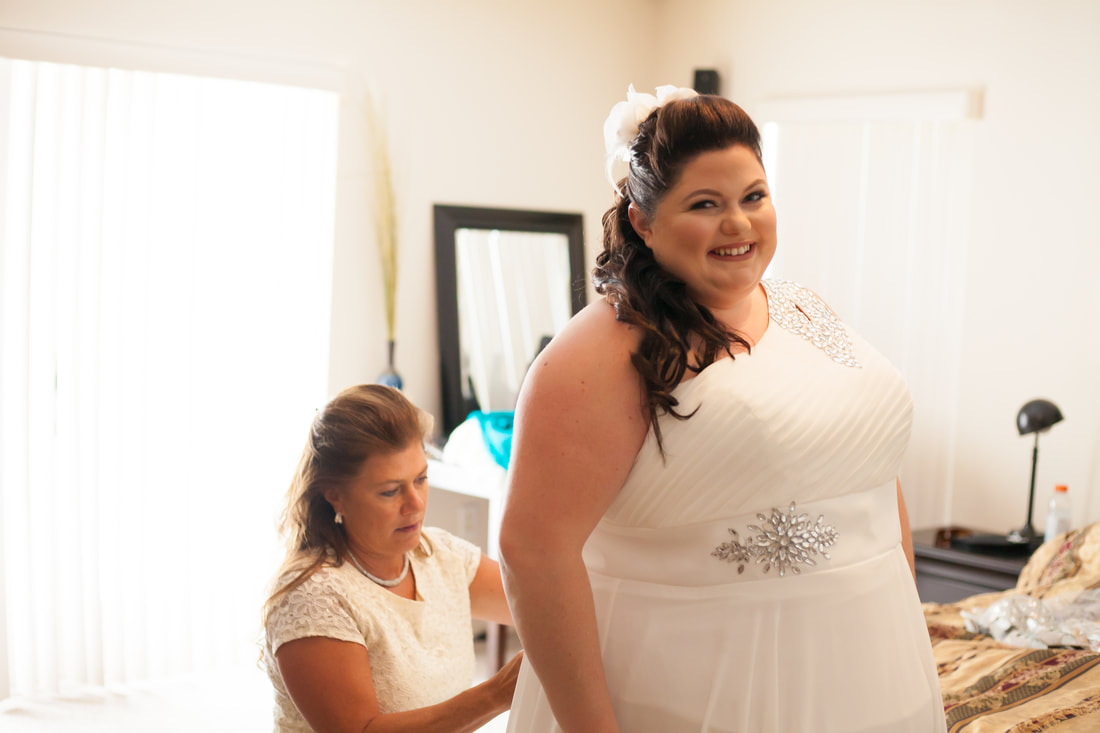 Brides mother fastens her dress in Inverness FL
