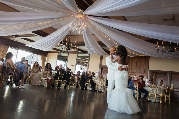 Wide angle photo of bride and groom starting their first dance