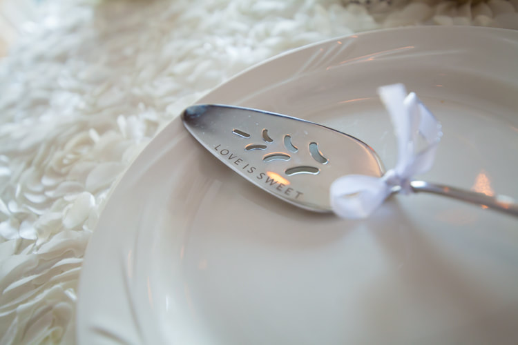 close up of cake server with the words life is sweet etched into it