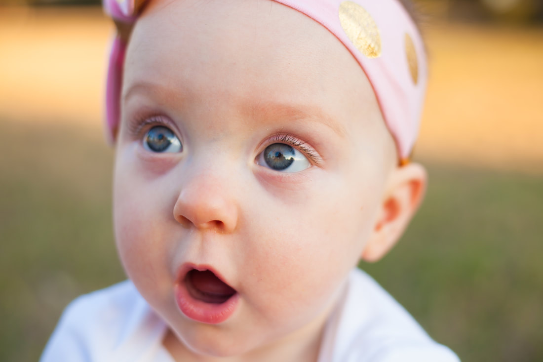 Close up of surprised baby girl with big eyes in Tampa FL