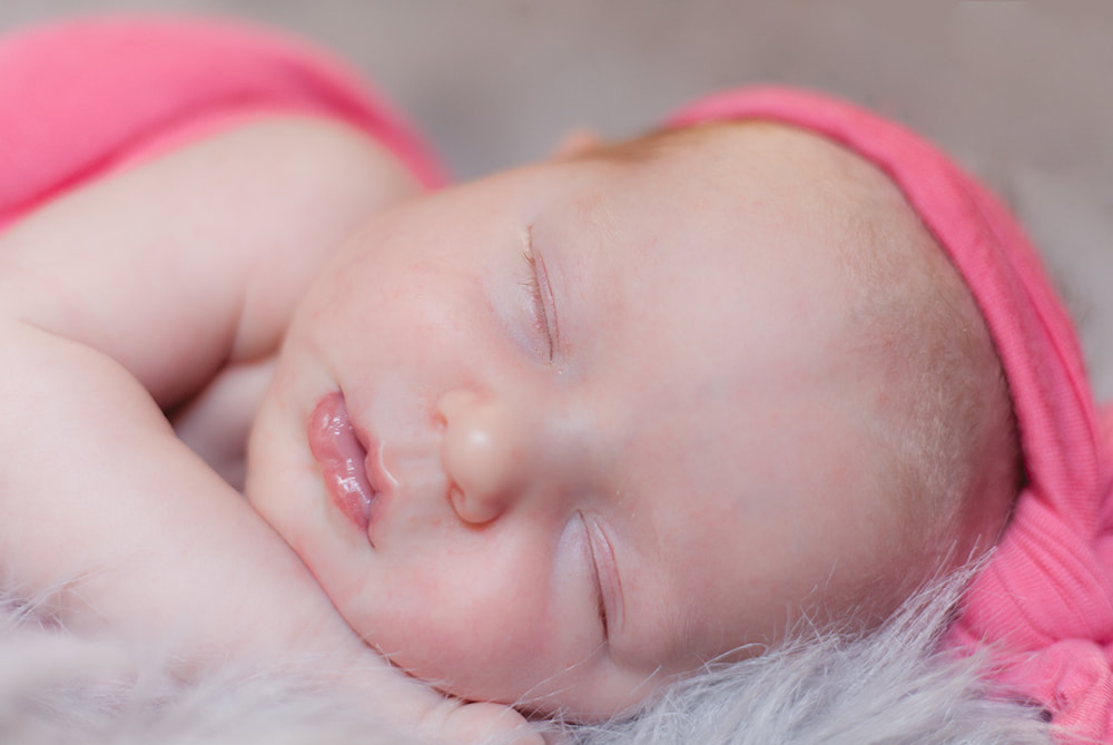 close up of relaxed newborn baby girl's face