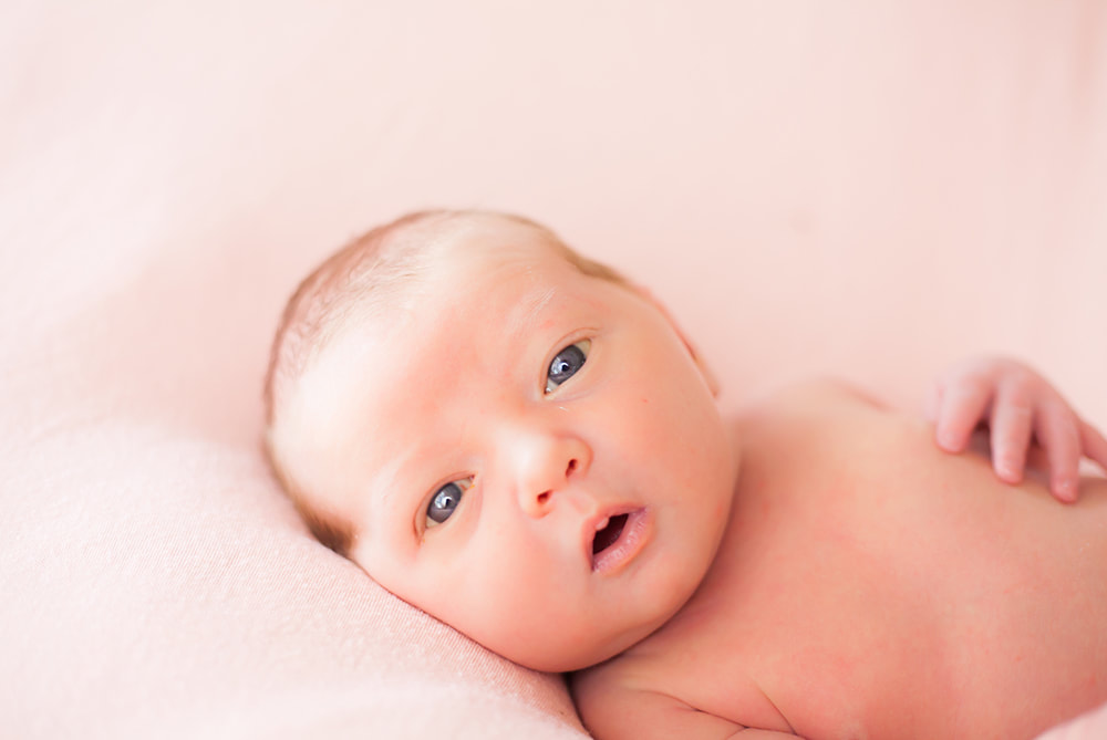 Close up of newborn baby girl looking into the camera in Tampa Florida