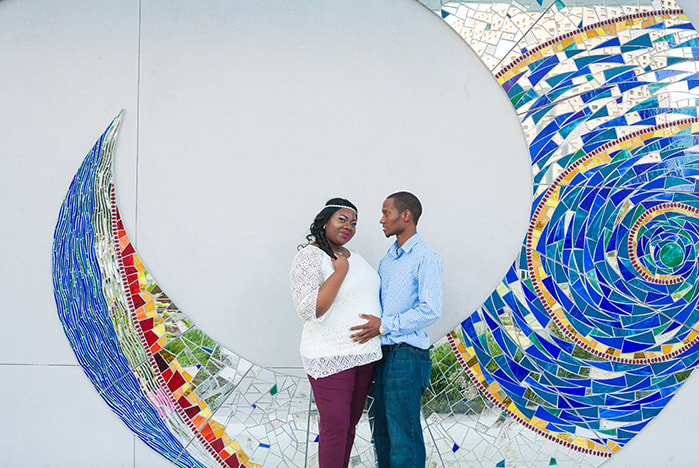 Maternity photo of couple in front of beautiful mosaic wall mural in Curtis Hixon Park in Tampa FL