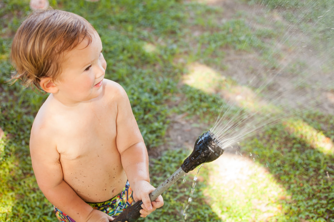 Toddler sprays hose