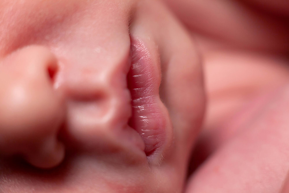 Extreme close up of sleeping baby's nose, lips, and chin